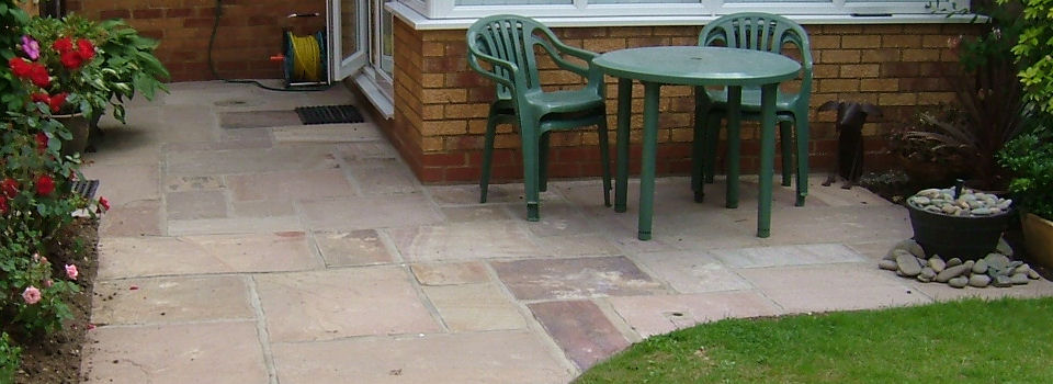 New paved patio with stone water feature